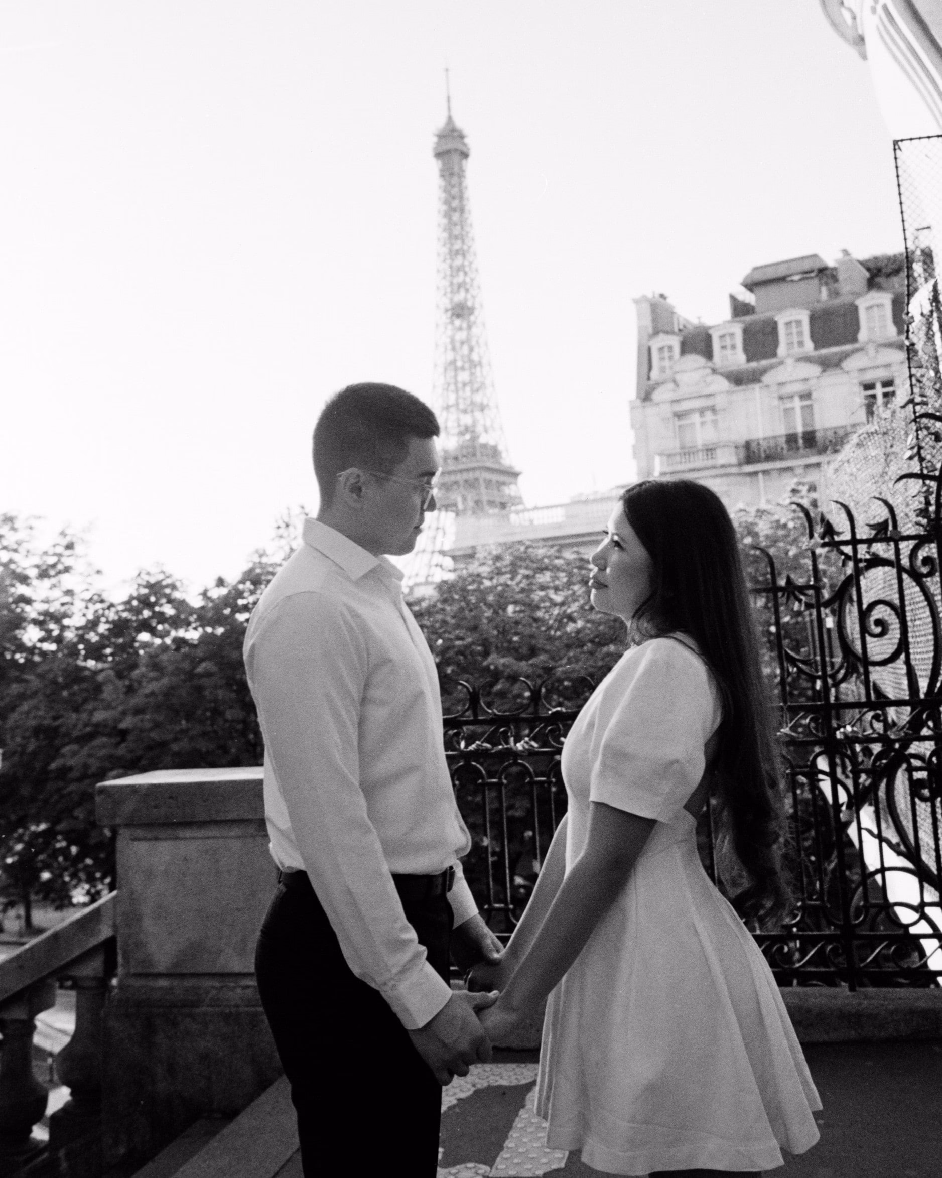 Couple portrait in front of the Eiffel Tower, shot on black and white film, paris, engagement session, couple session, film photography, black and white
