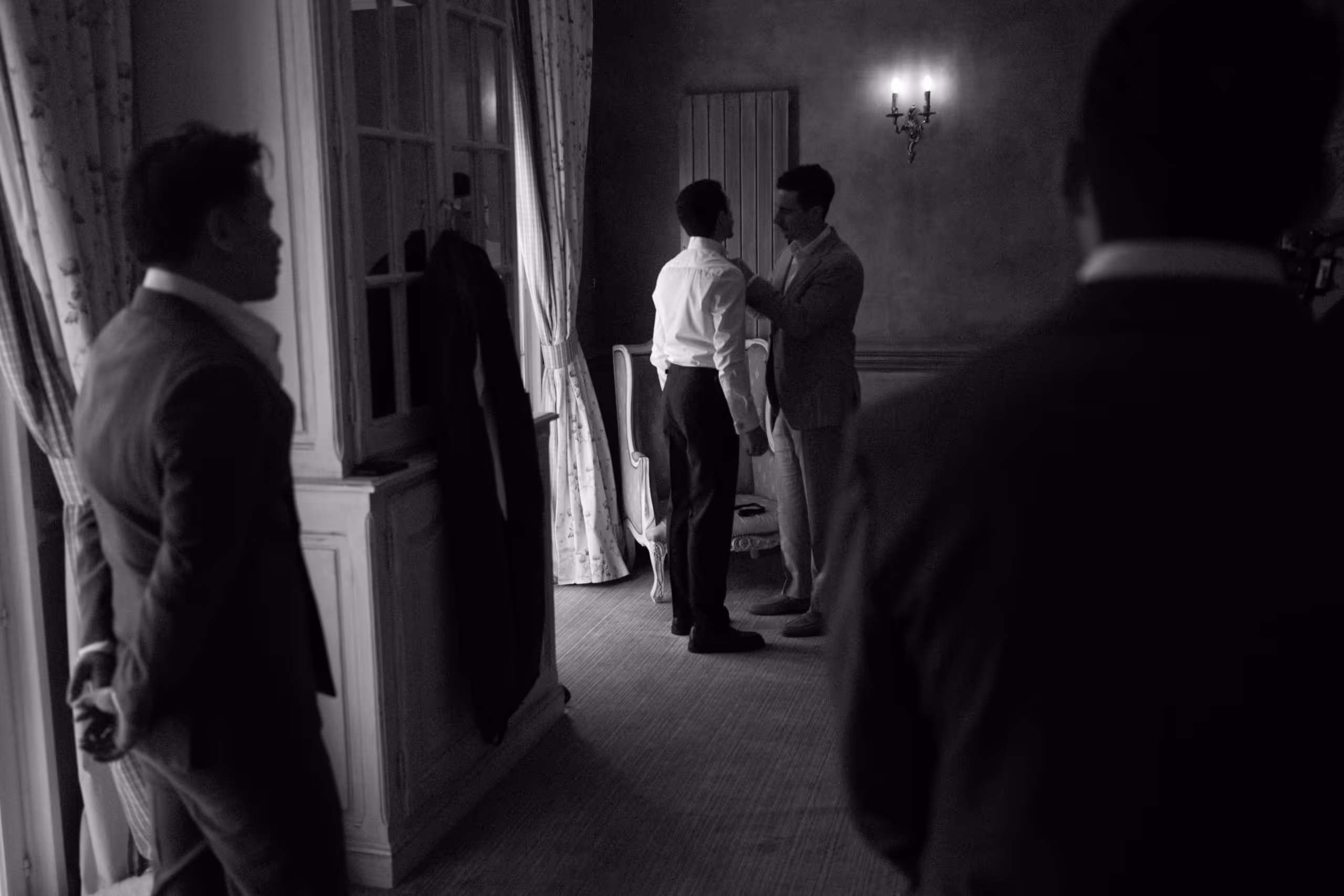 Groom dressing with his groomsmen in a chateau room before the ceremony, bastide d'astres, provence wedding, south of france